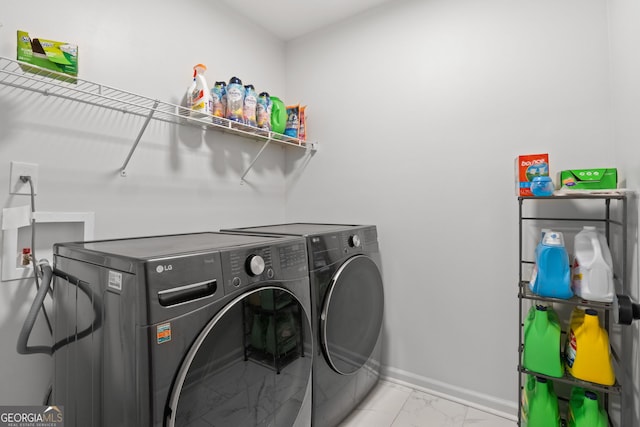 washroom with independent washer and dryer