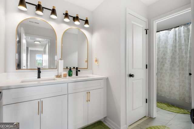 bathroom featuring vanity and curtained shower