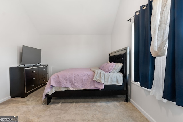 carpeted bedroom featuring lofted ceiling