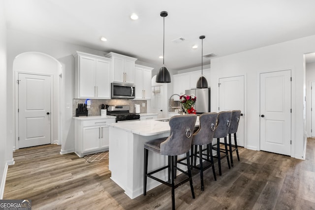 kitchen with white cabinets, appliances with stainless steel finishes, and sink