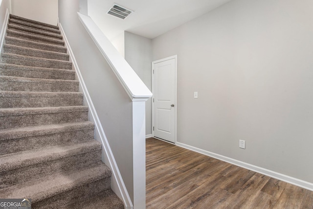 stairway with hardwood / wood-style floors