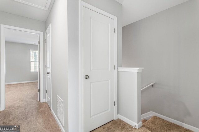 hallway featuring light carpet