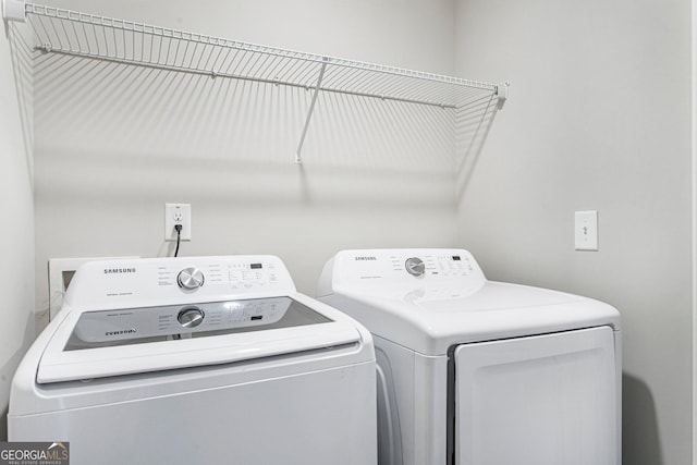 clothes washing area with separate washer and dryer