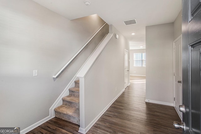 stairway featuring wood-type flooring