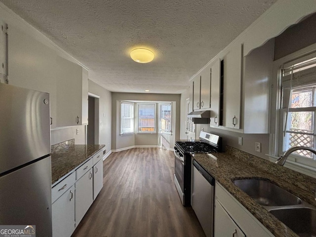 kitchen with sink, white cabinets, a textured ceiling, and appliances with stainless steel finishes