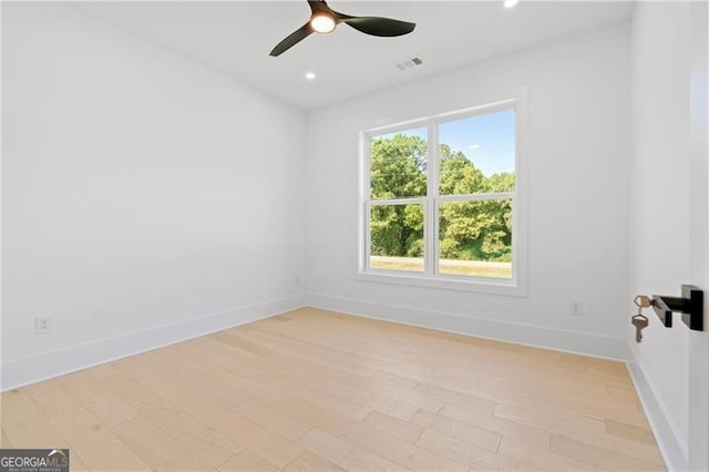 empty room featuring ceiling fan and light hardwood / wood-style floors