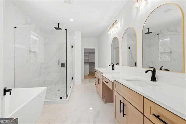 bathroom featuring vanity and shower with separate bathtub