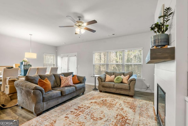 living room featuring ceiling fan and hardwood / wood-style flooring