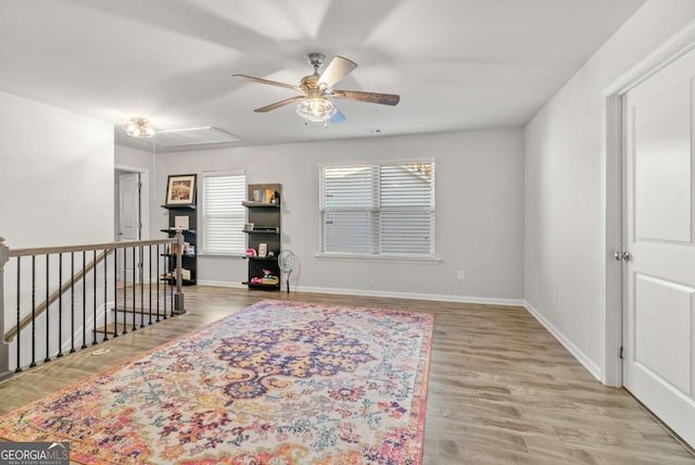 living area featuring wood-type flooring and ceiling fan