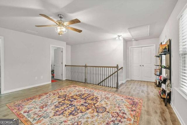 interior space with ceiling fan and light hardwood / wood-style flooring