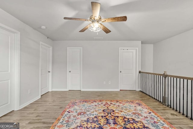 spare room featuring ceiling fan and light hardwood / wood-style floors