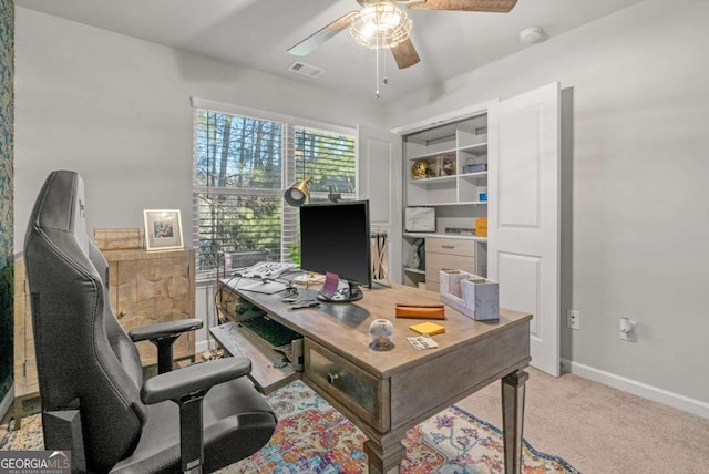 carpeted office featuring ceiling fan