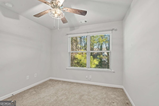 empty room with ceiling fan and light colored carpet