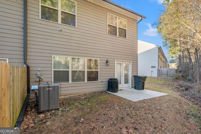 back of house featuring french doors, central AC, and a patio area