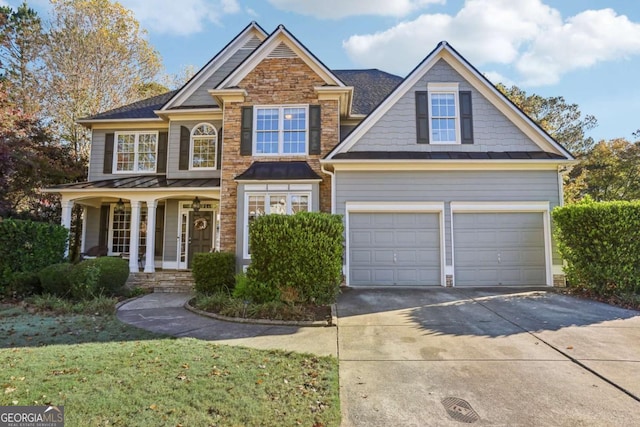 craftsman-style house featuring a porch, a garage, and a front lawn