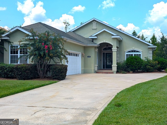 ranch-style house with a front yard and a garage