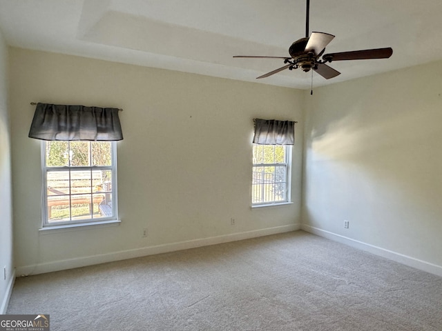 carpeted spare room with ceiling fan