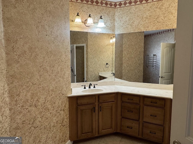 bathroom with tile patterned flooring and vanity