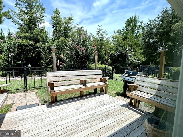 wooden terrace with a grill