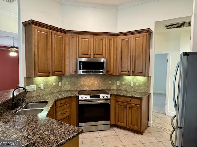 kitchen featuring tasteful backsplash, stainless steel appliances, ceiling fan, sink, and light tile patterned floors