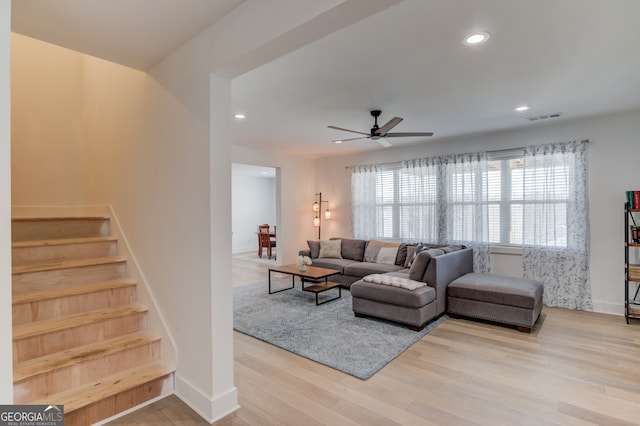 living room with ceiling fan and light wood-type flooring