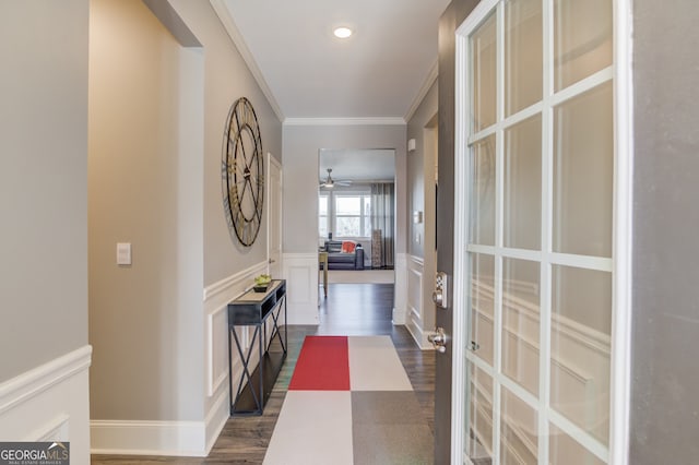 corridor with dark hardwood / wood-style flooring and ornamental molding