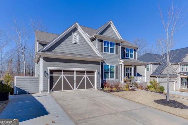 view of front of property with covered porch and a garage