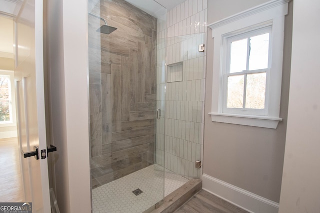 bathroom featuring a tile shower and hardwood / wood-style flooring