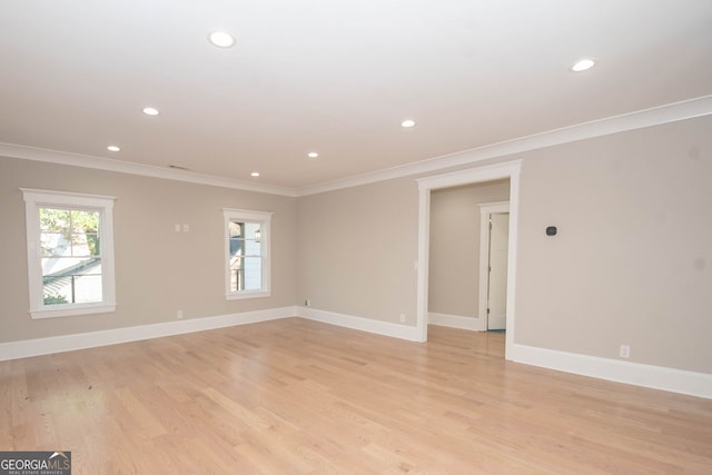 empty room featuring light hardwood / wood-style flooring and ornamental molding