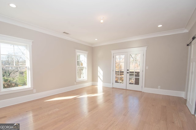 unfurnished room featuring a healthy amount of sunlight, ornamental molding, and french doors