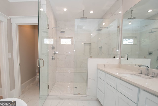 bathroom with vanity, toilet, and a shower with door