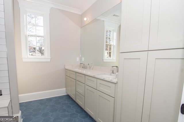 bathroom featuring crown molding, tile patterned flooring, and vanity