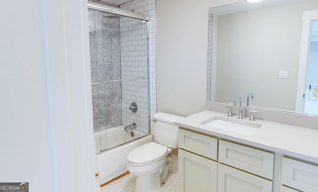 full bathroom featuring shower / bath combination with glass door, tile patterned floors, vanity, and toilet