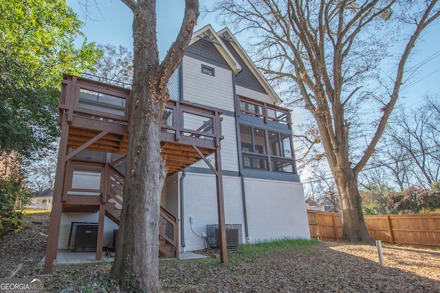 rear view of house with a sunroom and central air condition unit