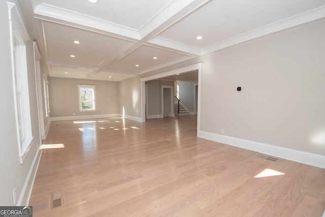 empty room with light hardwood / wood-style flooring, beam ceiling, crown molding, and coffered ceiling