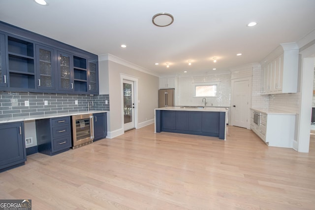 kitchen with backsplash, high quality fridge, blue cabinets, white cabinets, and wine cooler