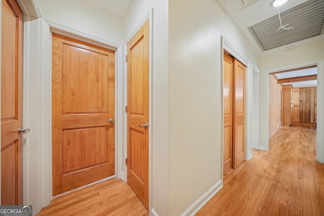 hallway with light hardwood / wood-style floors