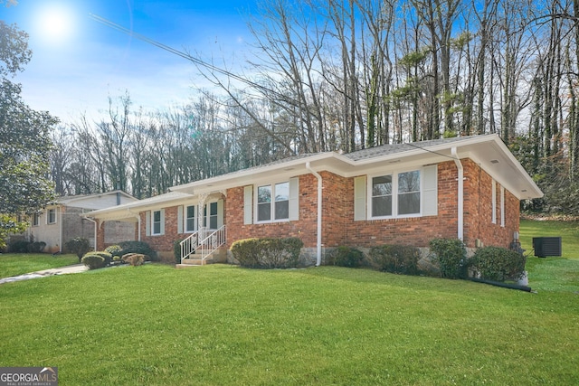 ranch-style home featuring central AC unit and a front lawn