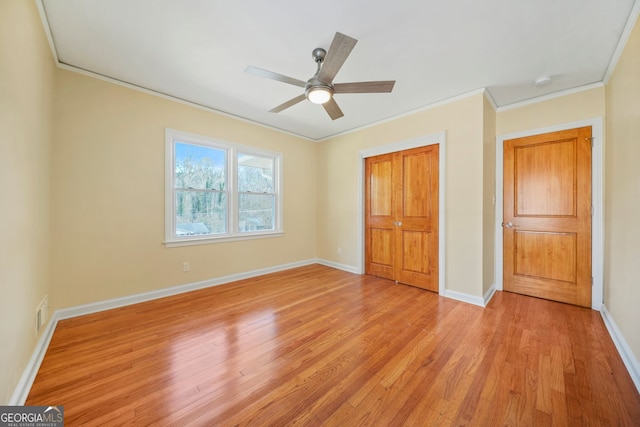 unfurnished bedroom with ceiling fan, ornamental molding, and light hardwood / wood-style flooring