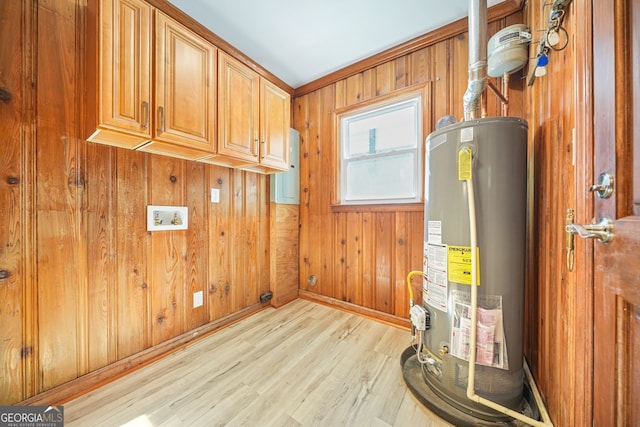 utility room featuring gas water heater and electric panel