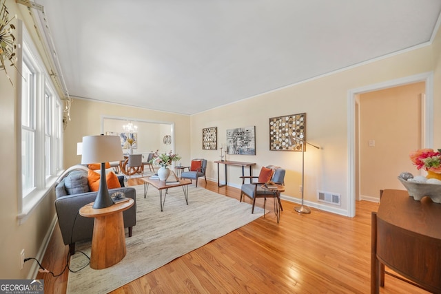 living room featuring a chandelier and light hardwood / wood-style floors