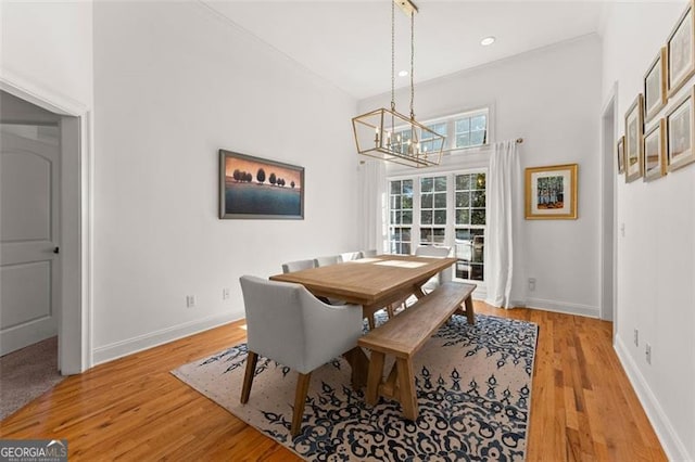 dining room featuring an inviting chandelier and light hardwood / wood-style flooring