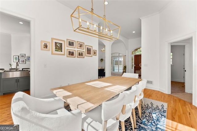 dining area with light wood-type flooring and sink