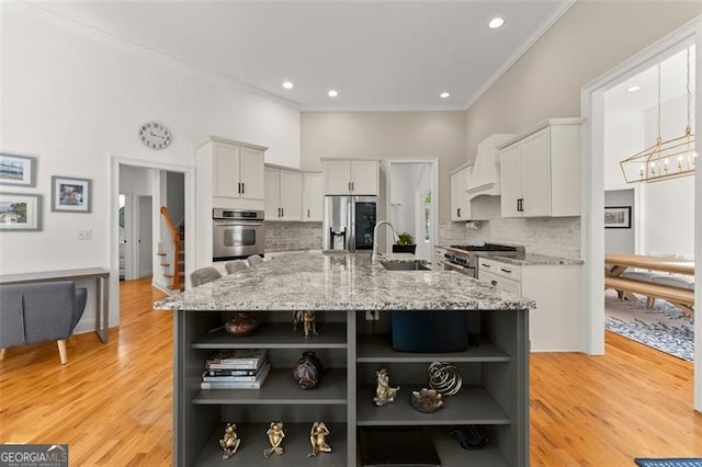 kitchen with backsplash, stainless steel appliances, light stone counters, and a spacious island