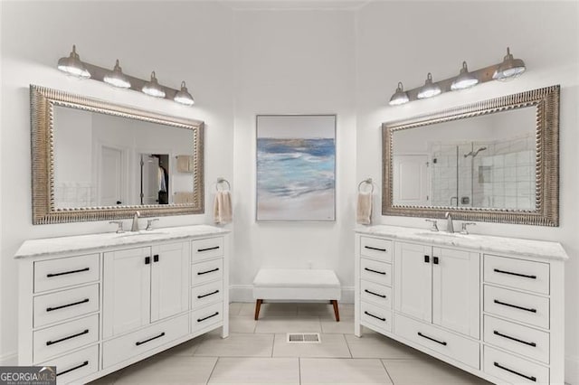 bathroom with tile patterned flooring, vanity, and a shower with shower door