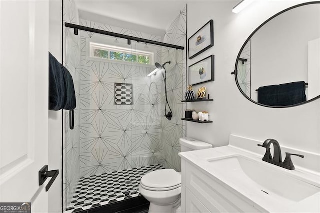 bathroom with toilet, vanity, and a stall shower