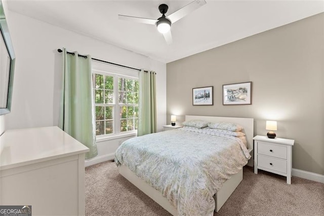 bedroom featuring baseboards, ceiling fan, and light colored carpet