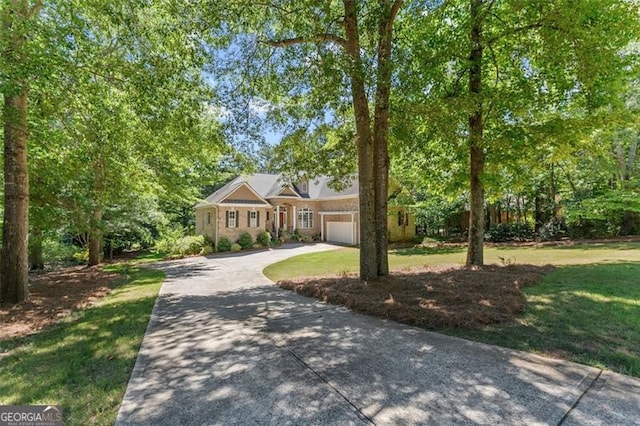 view of front of home featuring a front yard and a garage