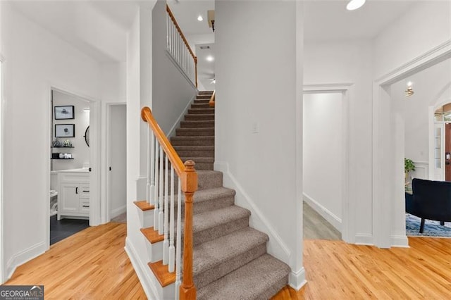 stairs featuring wood-type flooring