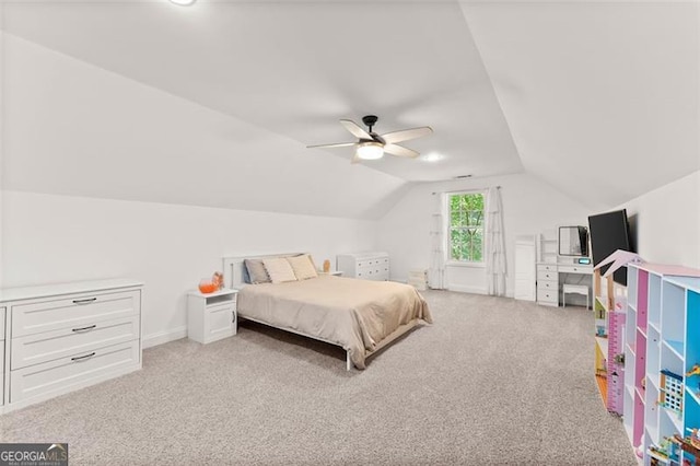 bedroom featuring a ceiling fan, light colored carpet, and vaulted ceiling